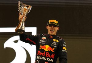 ABU DHABI, UNITED ARAB EMIRATES - DECEMBER 12: Race winner and 2021 F1 World Drivers Champion Max Verstappen of Netherlands and Red Bull Racing celebrates on the podium during the F1 Grand Prix of Abu Dhabi at Yas Marina Circuit on December 12, 2021 in Abu Dhabi, United Arab Emirates. (Photo by Kamran Jebreili - Pool/Getty Images) // Getty Images / Red Bull Content Pool  // SI202112120404 // Usage for editorial use only //
